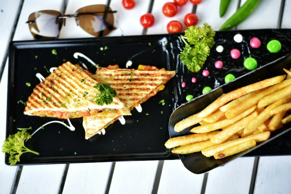 Grilled cheese sandwich with french fries and cherry tomatoes.